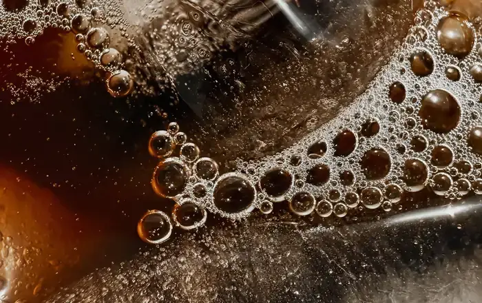 Cola with bubbles, close-up